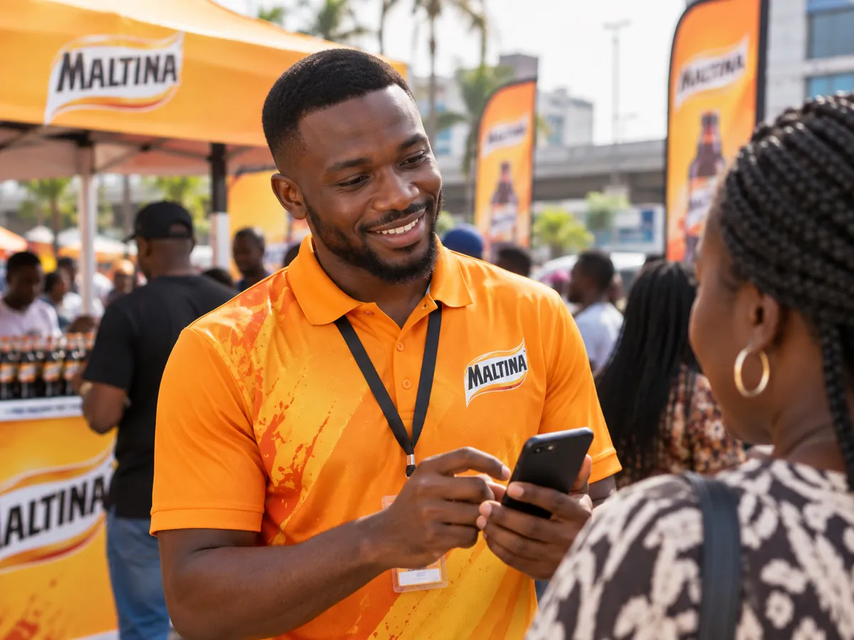A Maltina steward helping a visitor share her word at an activation